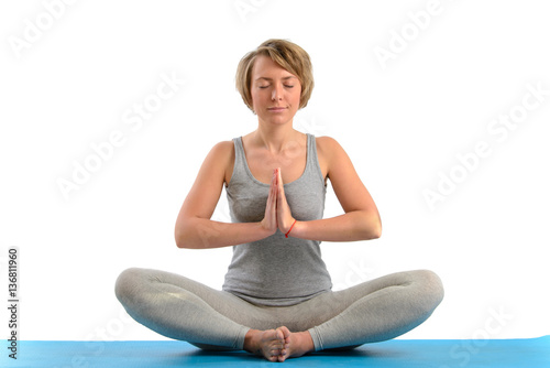 Young yoga woman meditating in the lotus position. Isolated on w