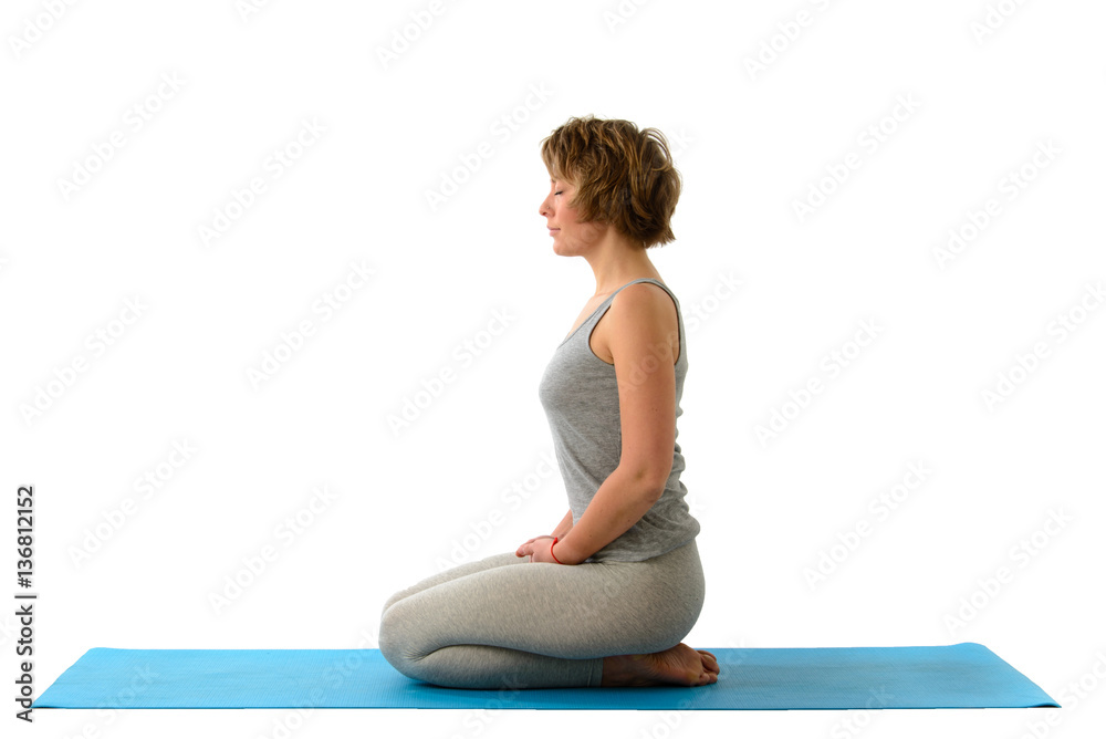 Young yoga woman in the virasana position. Isolated on white bac Young yoga woman in the virasana position. Isolated on white bac