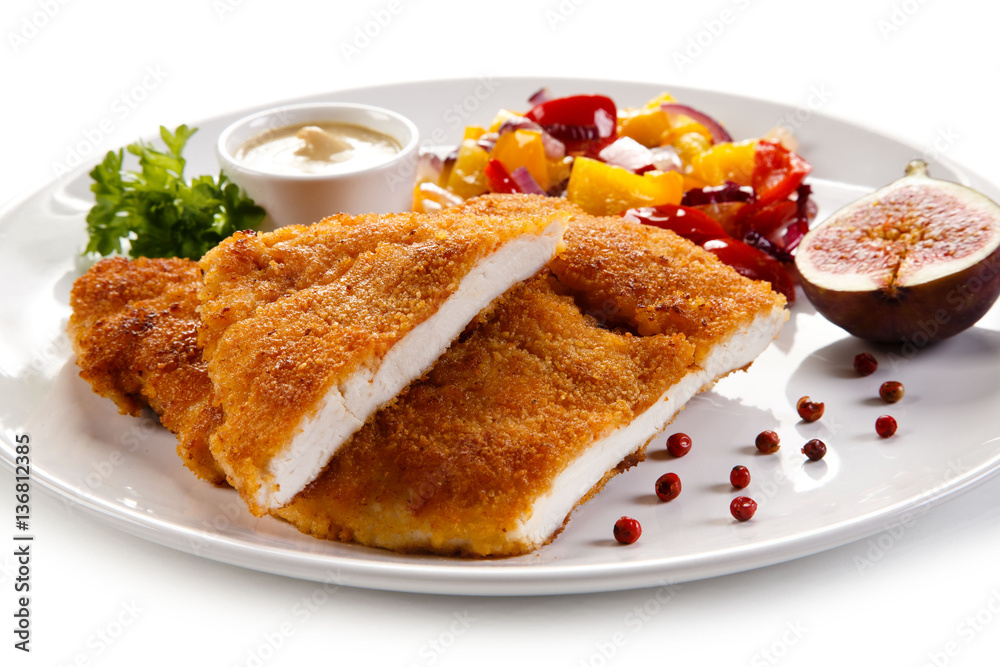 Fried pork chop coat in breadcrumbs and vegetable salad Fried pork chop coat in breadcrumbs and vegetable salad