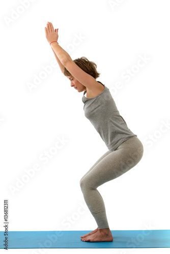 Young yoga woman in the ubhaya utkatasana position. Isolated on