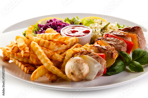 Kebabs - grilled meat and vegetables on white background 