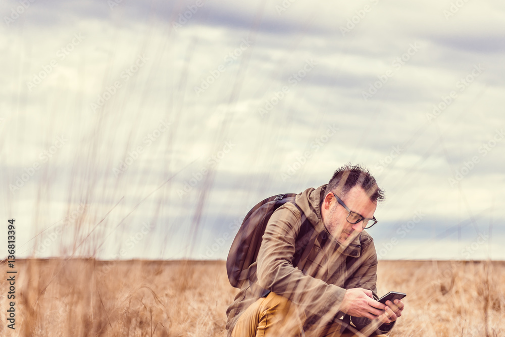 Hiker using smart phone Hiker using smart phone