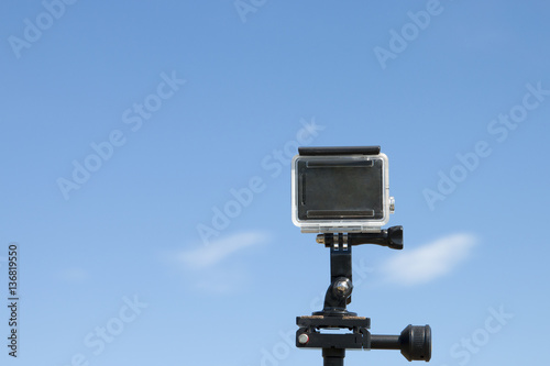 action camera on tripod with blue sky as background