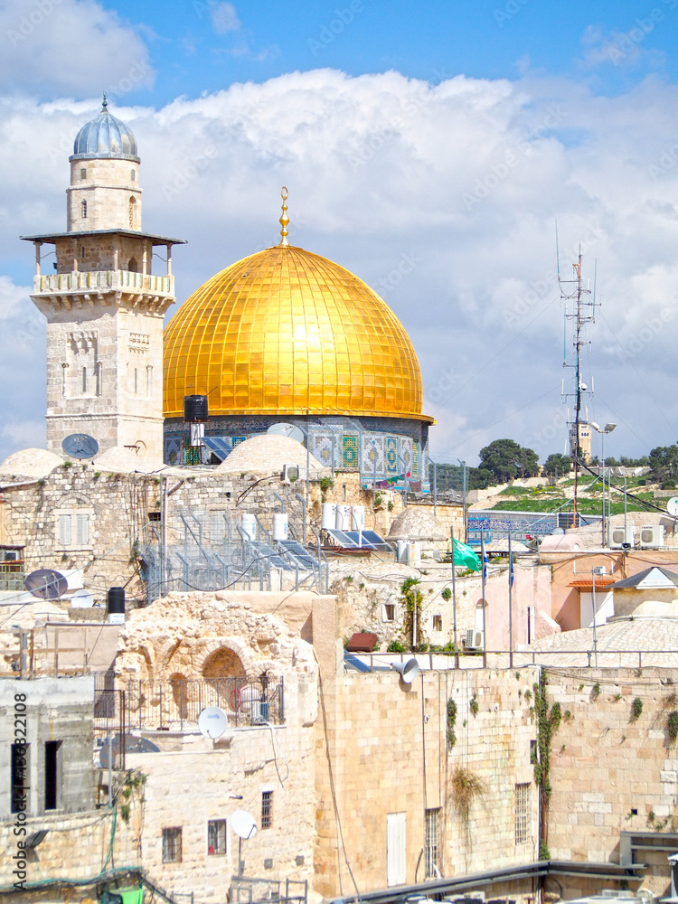 The golden dome of the mosque on the Temple Mount dominates this city view of historic Jerusalem Israel.
