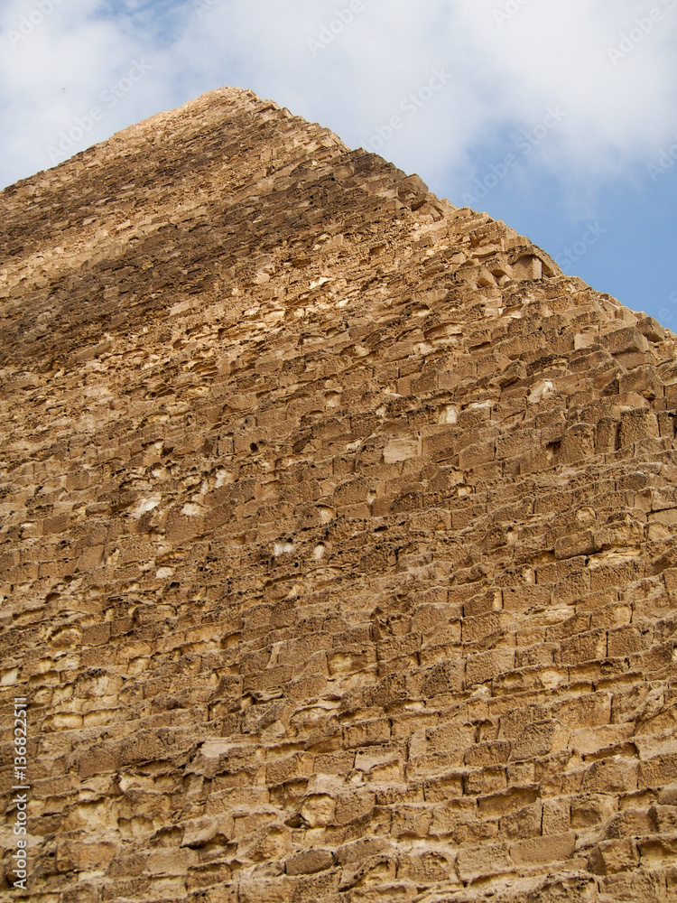 An upward view of one of the ancient pyramids of Giza in the desert outside of Cairo Egypt.