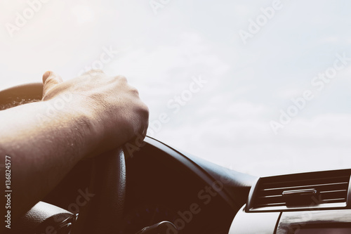 Man driving car using one hand