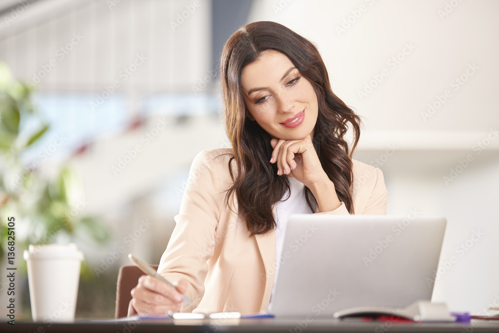 Professional businesswoman working on laptop in the office