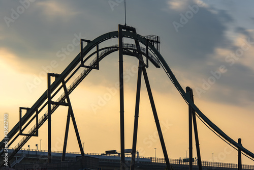 Panoramic shot of a roller coaster during the sunset