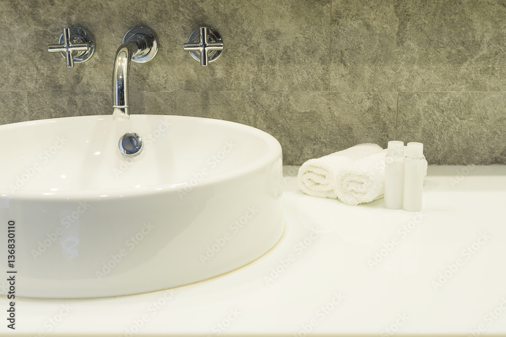 Fototapeta premium Bath room sink with white cleaning set in a hotel