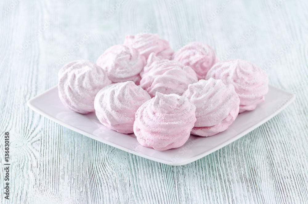 lovely pastel rose meringues, zephyrs, marshmallows on the wooden vintage table lovely pastel rose meringues, zephyrs, marshmallows on the wooden vintage table
