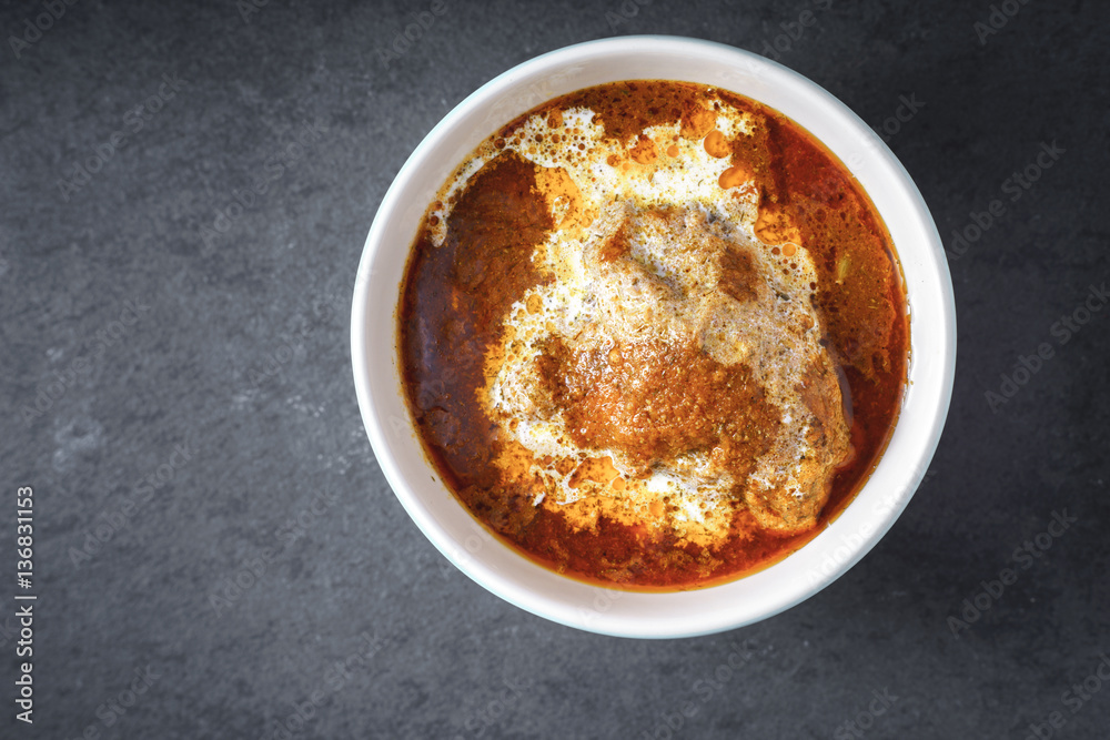 Slices Butter Chicken with cream in a bowl Slices Butter Chicken with cream in a bowl