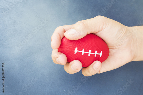 Soft rugby ball in hand for hand and finger exerciser