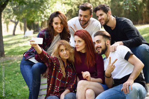 Group of friends taking selfie in urban background © javiindy