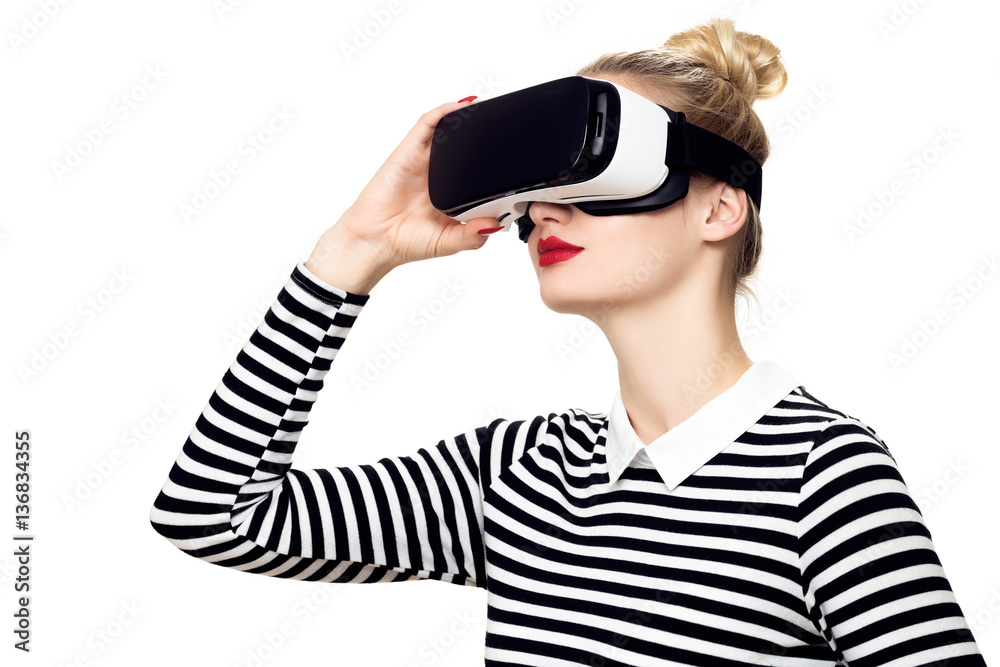 Attractive woman wearing virtual reality glasses. VR headset. Virtual reality concept on white background. Attractive woman wearing virtual reality glasses. VR headset. Virtual reality concept on white background.