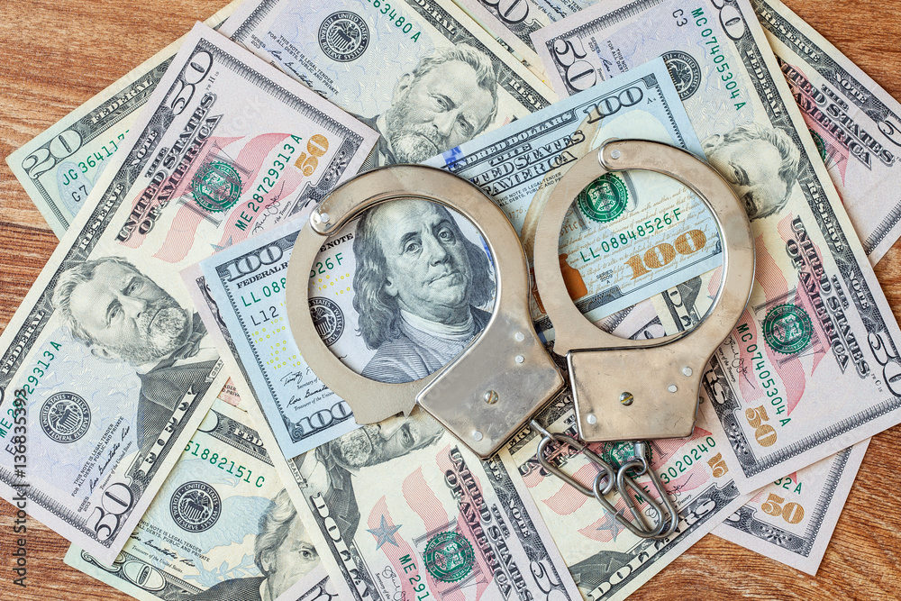 The dollars and handcuffs. The dollars and handcuffs.