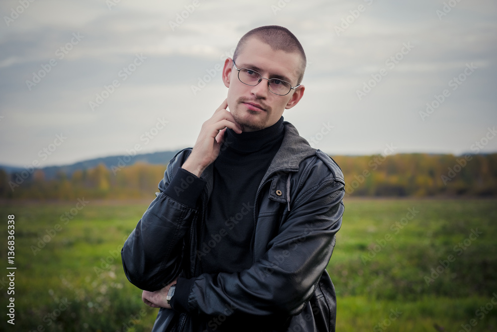 Bald man outdoor portrait.Man posing with leather jacket Bald man outdoor portrait.Man posing with leather jacket