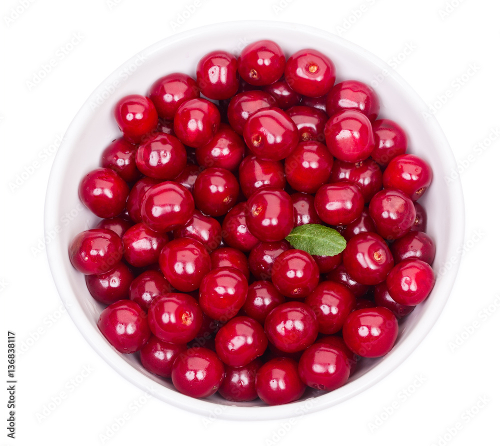 Bowl of fresh red cherries and green leaf isolated on a white ba Bowl of fresh red cherries and green leaf isolated on a white ba