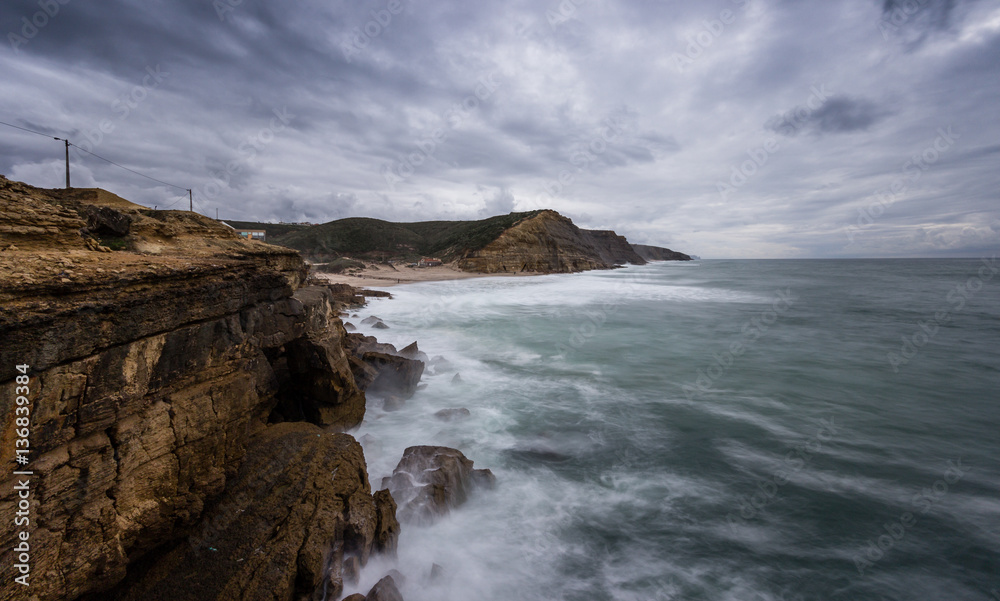 Rocky beach in Portugal in a stormy winter day. S.Juliao beach in ericeira