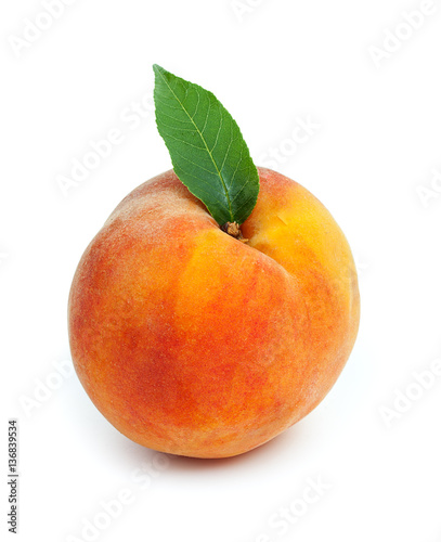 Fresh ripe juicy red peach with green leaf isolated on a white b