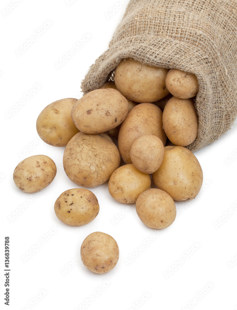 Potato tubers in a sack isolated on white