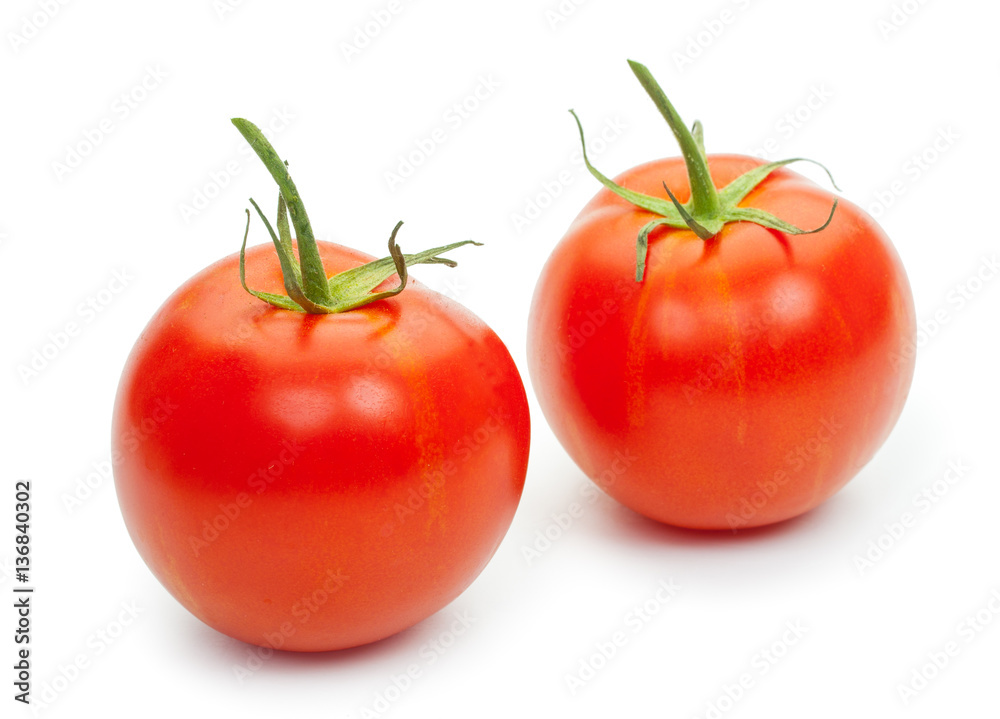 Two fresh tomatoes with green leaves isolated on white backgroun Two fresh tomatoes with green leaves isolated on white backgroun