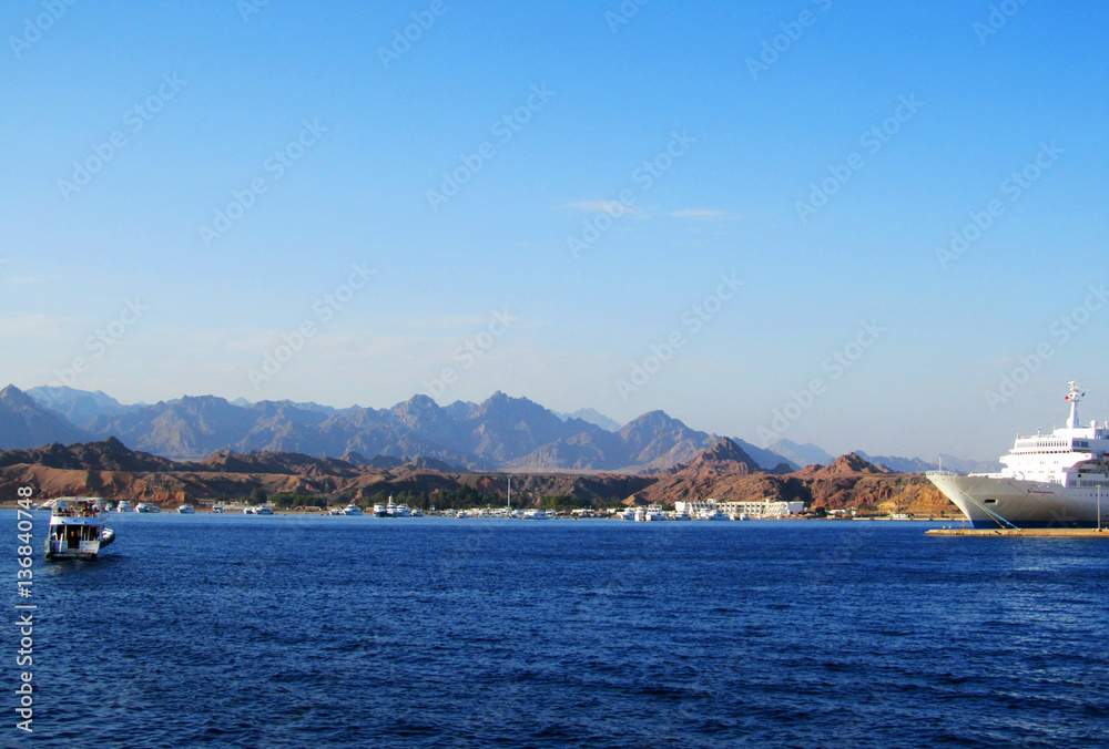 Boat and Ship at Red Sea with mountains in background