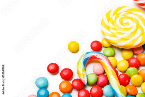 Colorful candies and lollipops isolated on white background