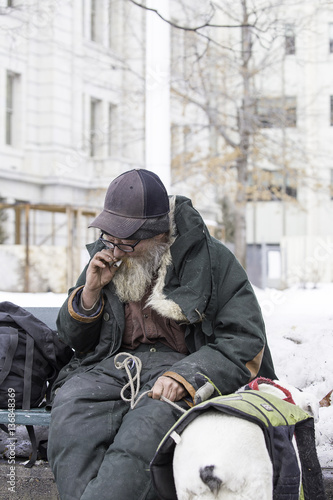 Homeless Man With Dog Smoking Tobacco rolled in a book page 