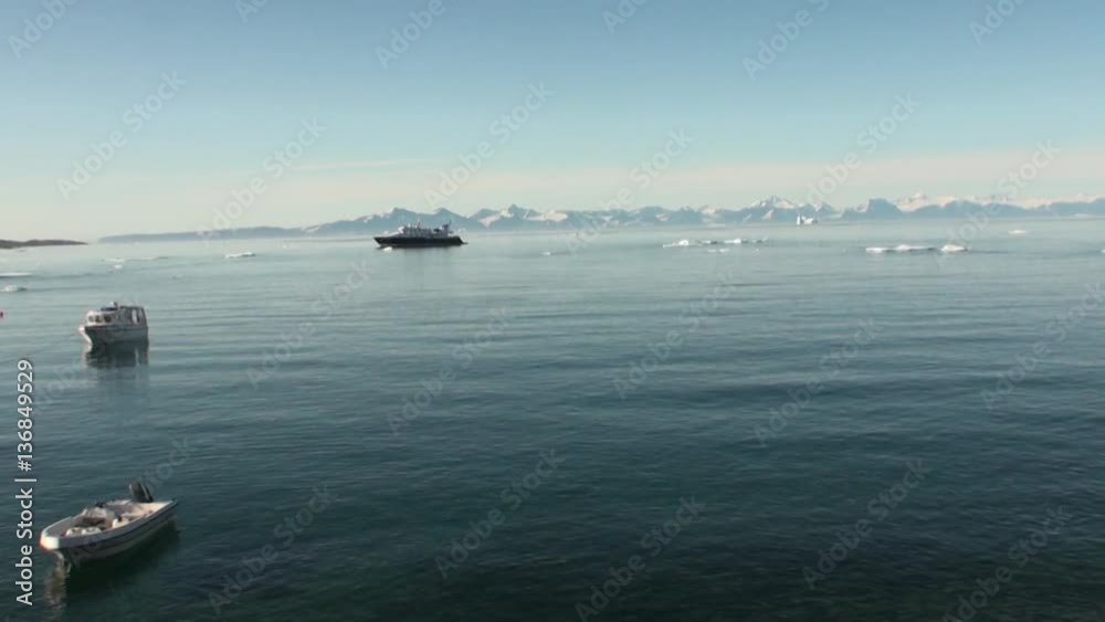 Iceland- 8 September 2016: Yacht on background of icebergs, snow and ice in the Arctic Ocean. Wilderness. Extreme tourism and travel in the cold polar north. Scenic coastline and blue water. Iceland- 8 September 2016: Yacht on background of icebergs, snow and ice in the Arctic Ocean. Wilderness. Extreme tourism and travel in the cold polar north. Scenic coastline and blue water.