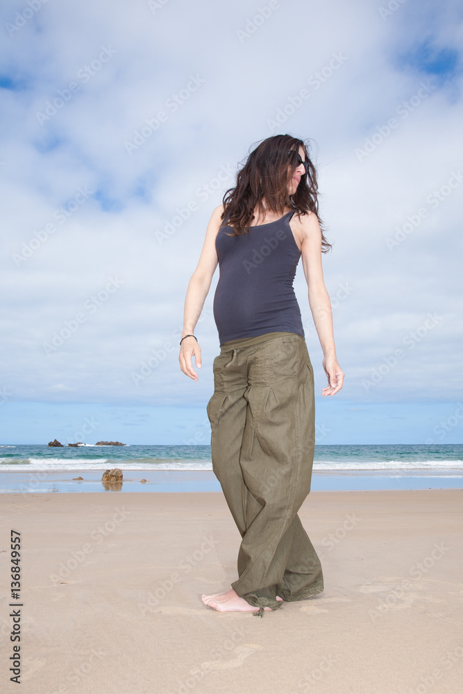 brunette brown hair pregnant woman with grey shirt green trousers and black sunglasses in holidays summer walking in sand beach ocean in Asturias Spain
brunette brown hair pregnant woman with grey shirt green trousers and black sunglasses in holidays summer walking in sand beach ocean in Asturias Spain