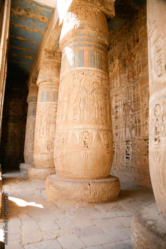Egyptian paintings, carving figures and hieroglyphs in columns and wall of landmark Temple of Ramses or Ramesses III at Medinet Habu, monument in Luxor, Egypt, Africa
 photo