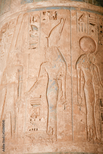 Egyptian carving figure queen and hieroglyphs in column of landmark Temple of Ramses or Ramesses III at Medinet Habu, monument in Luxor, Egypt, Africa 
