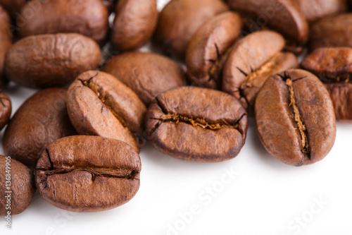 roasted coffee beans isolated in white background. Roasted coffee beans background close up. Coffee beans pile from top on white background with copy space for text. Good morning.