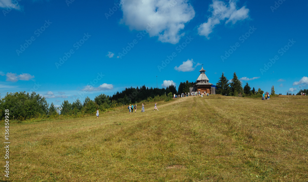 Wooden church against the blue sky. Clear sunny summer day in th Wooden church against the blue sky. Clear sunny summer day in th