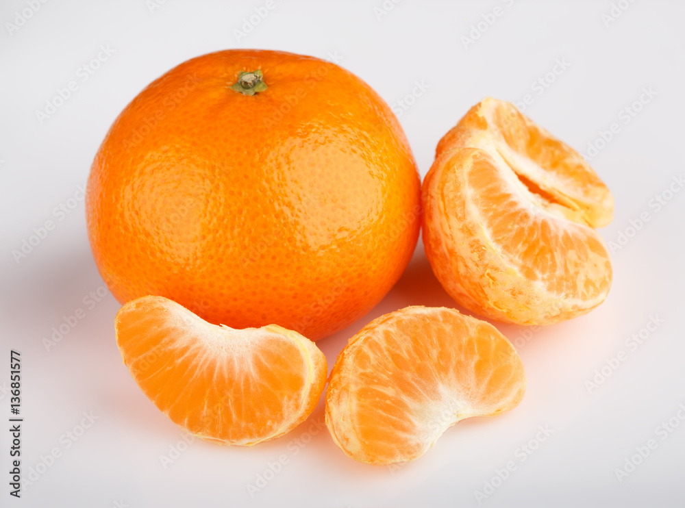 Ripe mandarin close-up on a white background. Tangerine orange. Colorful Food and drink still life concept. Fresh fruits and vegetables on color background. Clementine. Citrus. Fresh fruits. Diet. Ripe mandarin close-up on a white background. Tangerine orange. Colorful Food and drink still life concept. Fresh fruits and vegetables on color background. Clementine. Citrus. Fresh fruits. Diet.