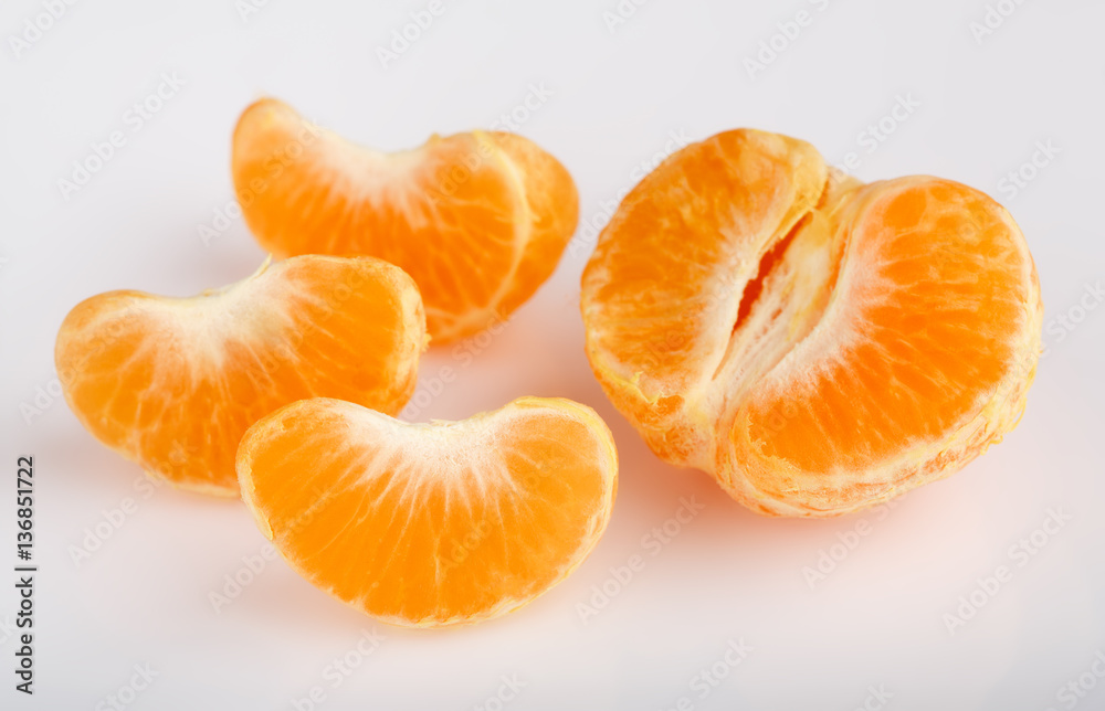 Ripe mandarin close-up on a white background. Tangerine orange. Colorful Food and drink still life concept. Fresh fruits and vegetables on color background. Clementine. Citrus. Fresh fruits. Diet. Ripe mandarin close-up on a white background. Tangerine orange. Colorful Food and drink still life concept. Fresh fruits and vegetables on color background. Clementine. Citrus. Fresh fruits. Diet.