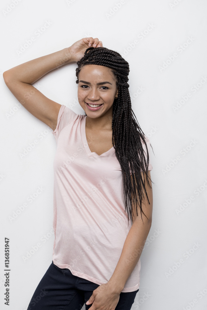 Young beautiful female leaning on a white wall Young beautiful female leaning on a white wall