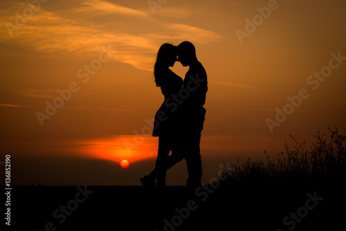 silhouette teenager lovers couple with sun between on sunset dusk sky background  black shadow hand drawn of people hug and kiss people passion in love concept decoration design valentines