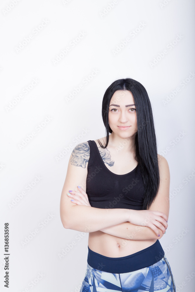 Cheerful athletic woman brunette. Woman in black sports top Cheerful athletic woman brunette. Woman in black sports top