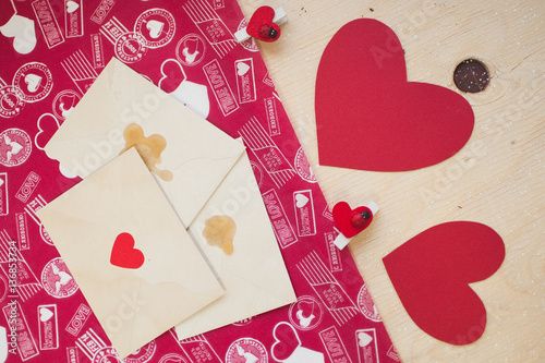Wallpaper Mural Red paper hearts with pins and envelopes on a wood table Torontodigital.ca