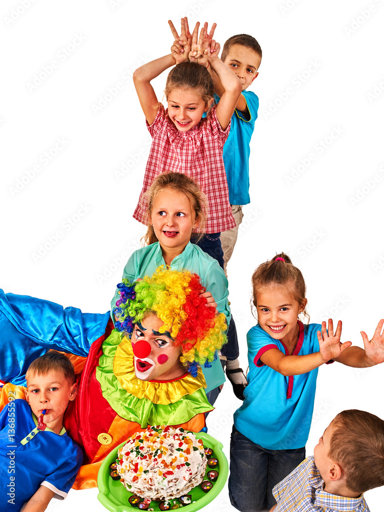 Birthday child clown playing with children. Kid holiday cakes celebratory in hands of events organizer man. Children give someone bunny ears . Fun of group people lying floor on white background.