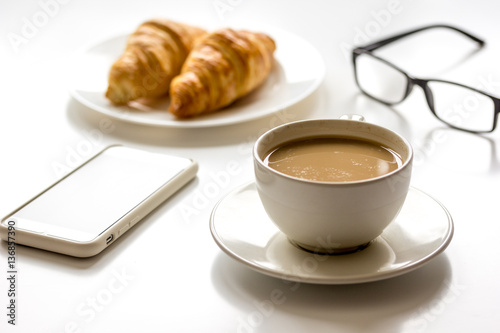 Breakfast for businessman with coffee and croissant on white table