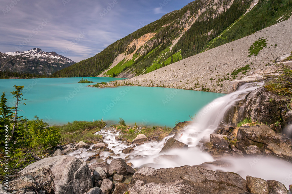 Waterfall from Matier glacier melt water flowing into the Turquoise Upper Joffre Lake in Beautiful British Columbia, Canada