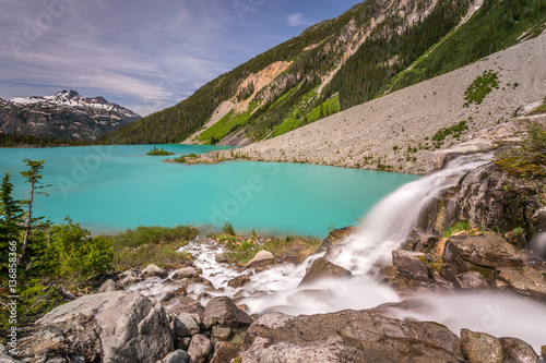 Waterfall from Matier glacier melt water flowing into the Turquoise Upper Joffre Lake in Beautiful British Columbia, Canada