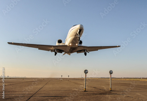 Business private jet in low level flight photo