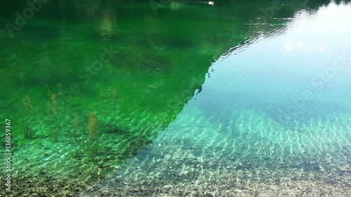 Reflections of trees and mountain at lake Bluntausee in austria photo