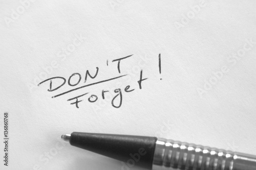 Don't Forget reminder note in hand writing on white paper