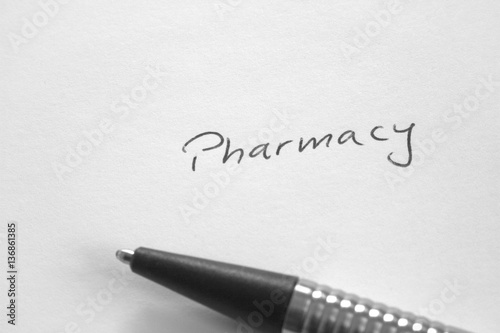 Handwritten word 'Pharmacy' on white paper