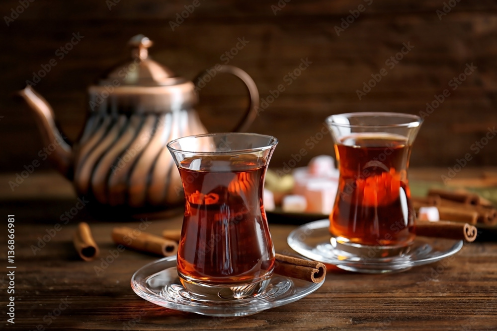 Turkish tea in traditional glass on wooden table closeup - obrazy, fototapety, plakaty 