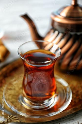 Turkish tea in traditional glass and metal teapot on tray closeup